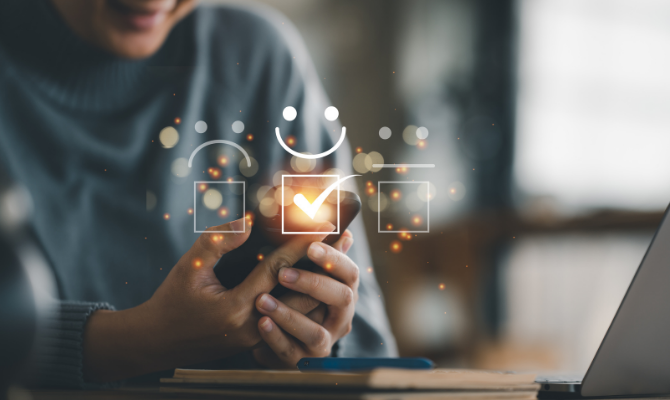 to represent customer experience this image shows a person holding a phone and smiley faces floating above it.