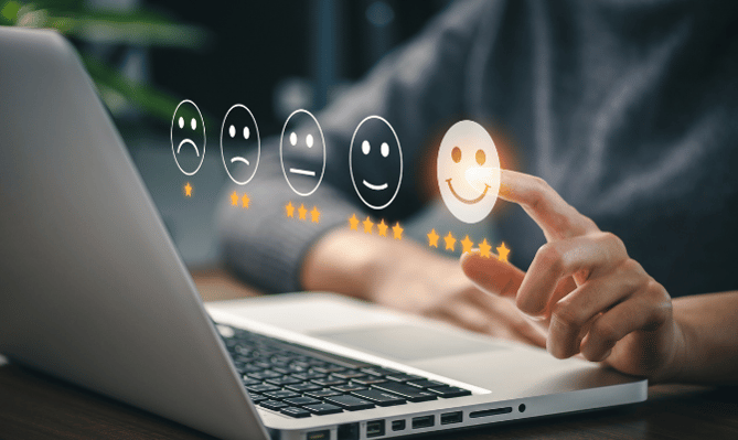 to represent measuring customer experience metrics this image shows some floating faces over a silver laptop.